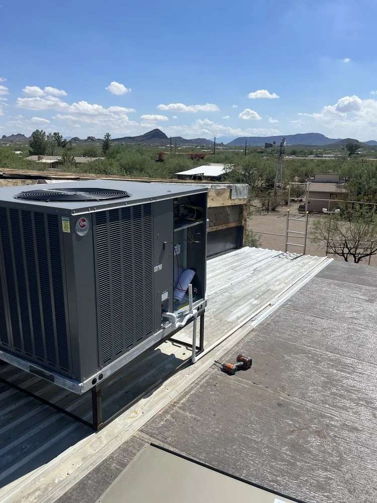 New energy-efficient HVAC King central air conditioner installation on the roof of a residential home on sunny day.
