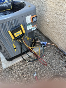 HVAC outdoor unit being maintenance by HVAC KING in tucson Arizona