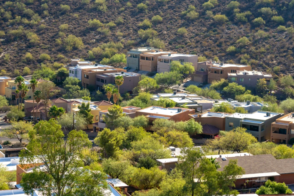 Tucson on homes in the green landscape in west tucson mountains, rolling into the hills of the desert. 